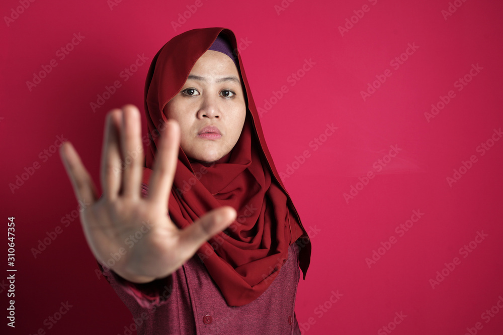 Muslim Lady in Red Shows Stop Gesture Muslim Lady in Red Shows Stop Gesture