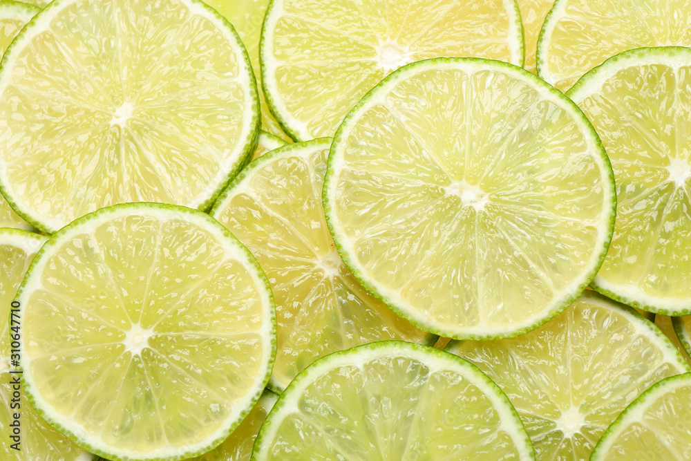 Many fresh juicy lime slices as background, top view Many fresh juicy lime slices as background, top view