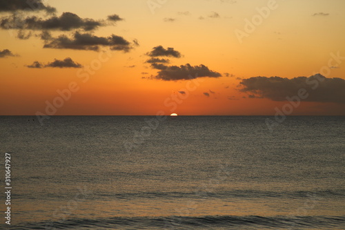 Beautiful crimson red sunset from the beach over the Caribbean Sea in Barbados  Atlantic Ocean
