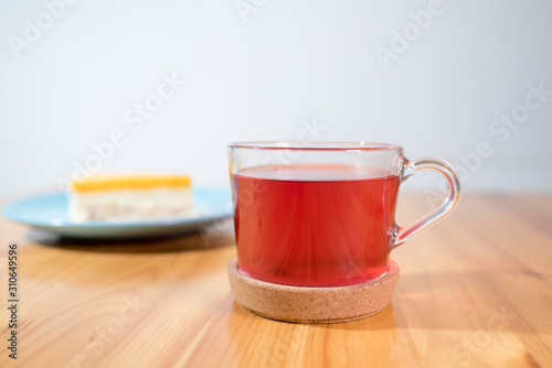 Mousse dessert and fruit tea on a large bright wooden table