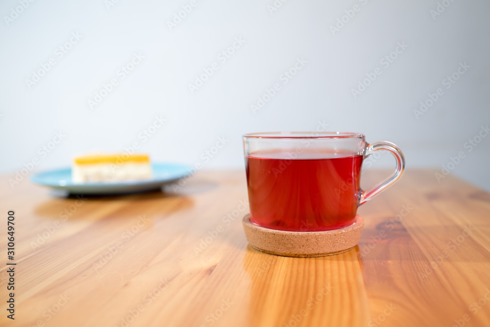 Mousse dessert and fruit tea on a large bright wooden table Mousse dessert and fruit tea on a large bright wooden table