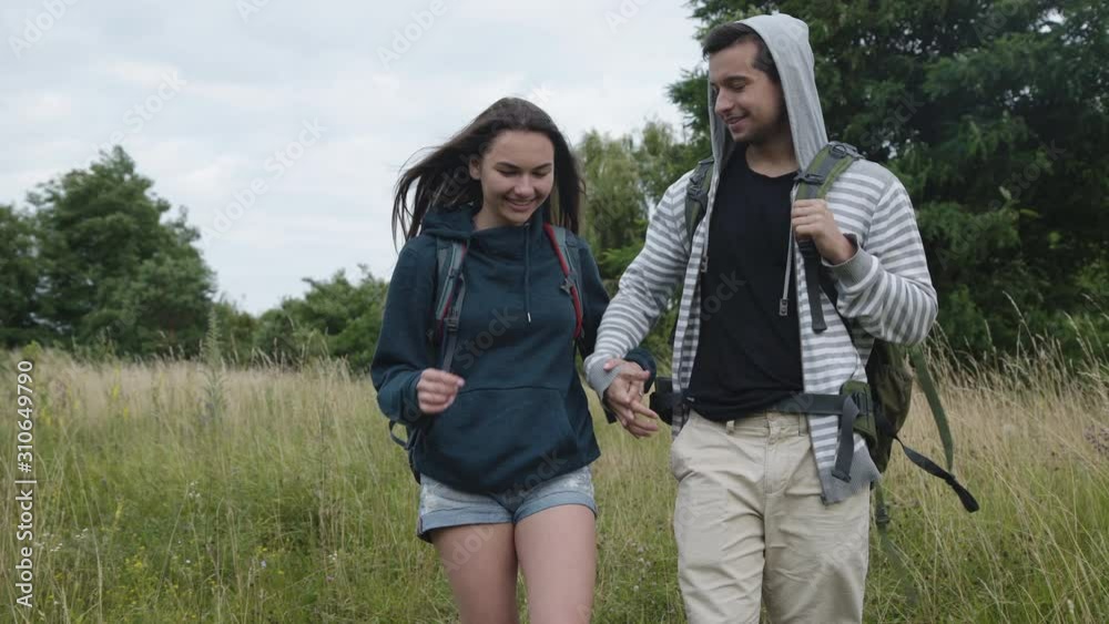 Happy couple in love walking on nature in embraces and kissing Happy couple in love walking on nature in embraces and kissing