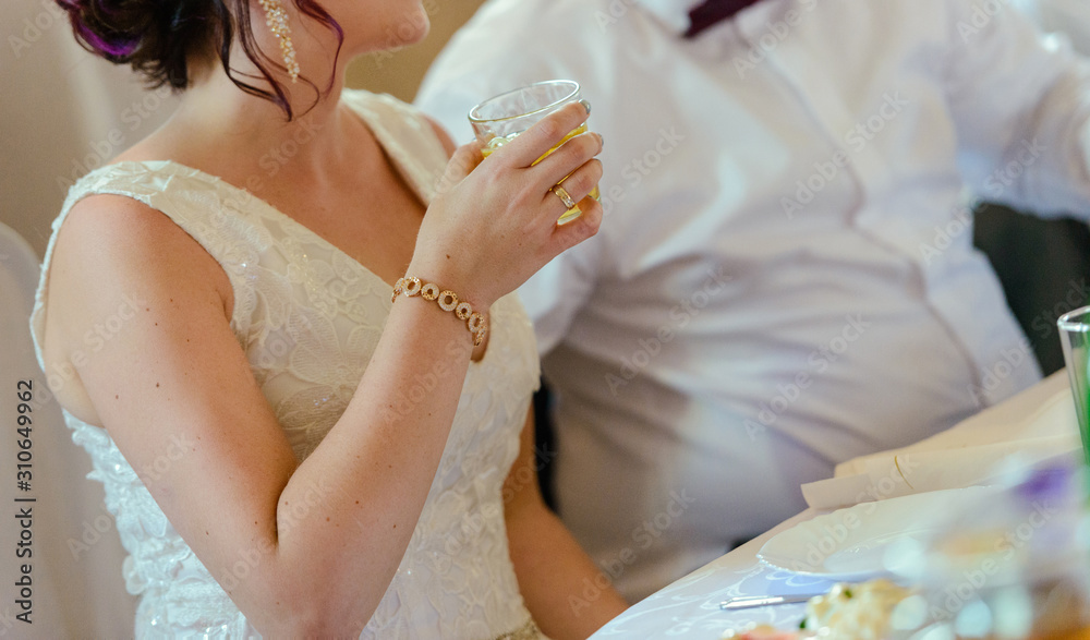 first toast of the bride and groom with a glass of champagne. first toast of the bride and groom with a glass of champagne.