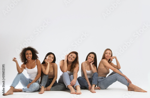 Group of women with different body types on light background