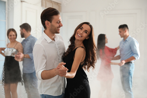 Lovely young couple dancing together at party Fototapet