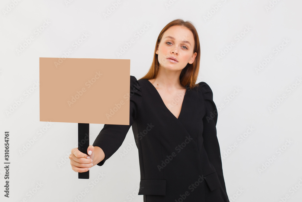 portrait of young business woman fighting for feminism, holding posters promoting, girl in black dress isolated over white background portrait of young business woman fighting for feminism, holding posters promoting, girl in black dress isolated over white background