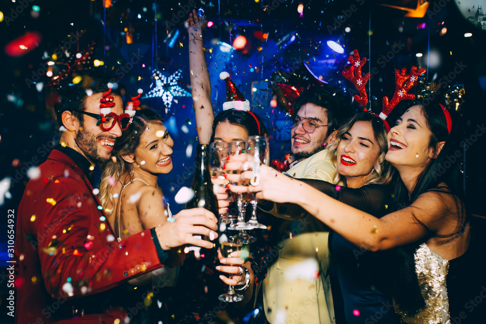 Group of friends having fun and toasting at New Year's party