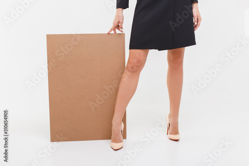business woman holding a blank billboard. elegance lady in black dress isolated on white background