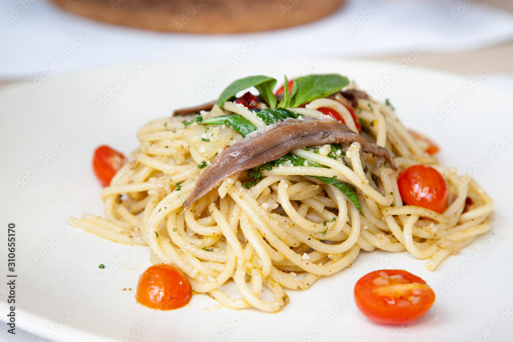 Spaghetti with anchovy, cherry tomato, onion, chili and pamersan cheese
