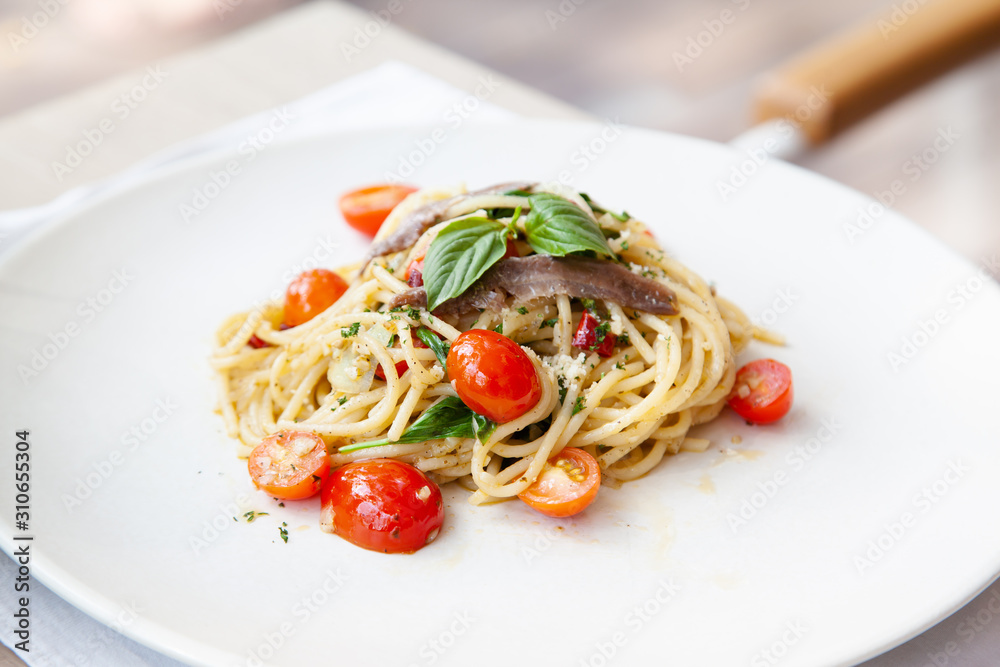 Spaghetti with anchovy, cherry tomato, onion, chili and pamersan cheese Spaghetti with anchovy, cherry tomato, onion, chili and pamersan cheese
