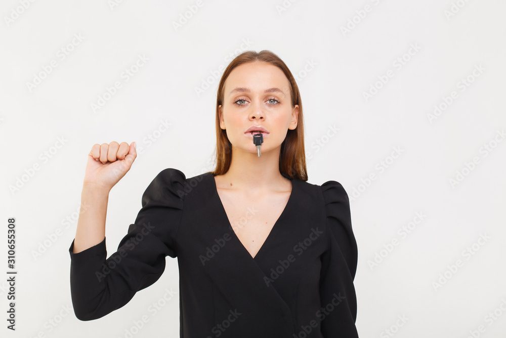 Closeup portrait of woman silent with a key in her mouth. Women's secrets. Silence is golden. Closeup portrait of woman silent with a key in her mouth. Women's secrets. Silence is golden.