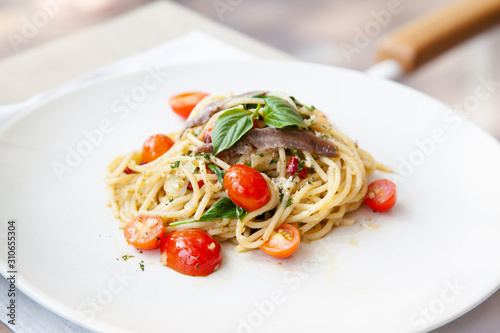 Spaghetti with anchovy, cherry tomato, onion, chili and pamersan cheese