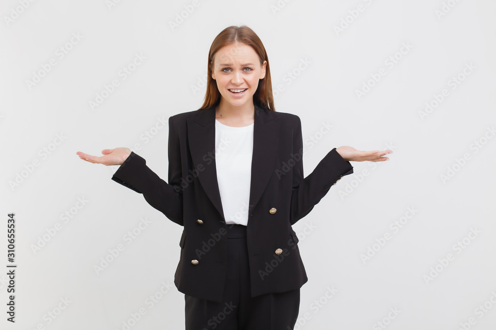 Indoor shot of perplexed worried confused good-looking young modern female wearing black jacket shrugging bothered hands sidewards, looking complicated cannot understand, standing clueless Indoor shot of perplexed worried confused good-looking young modern female wearing black jacket shrugging bothered hands sidewards, looking complicated cannot understand, standing clueless
