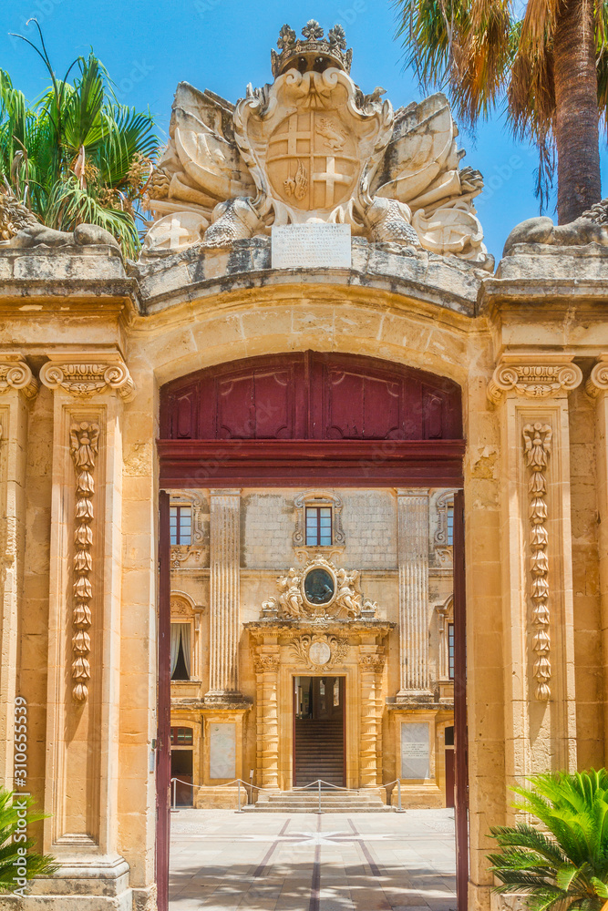 The entrance arch leading to the forecourt of the Vilhena Palace in Mdina, Malta, Europe.
