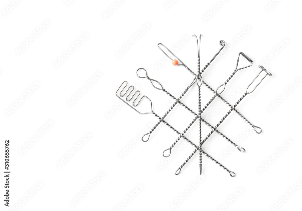 Set of logopedic probes on white background, top view. Speech therapist's tools Set of logopedic probes on white background, top view. Speech therapist's tools