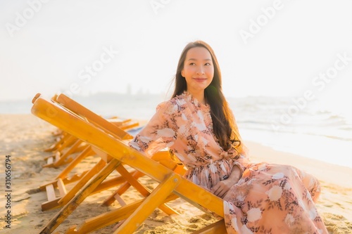 Portrait beautiful young asian women happy smile around outdoorn happy smile relax around tropical beach sea photo