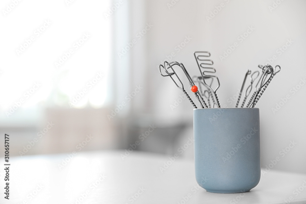Set of different logopedic probes in holder on light table, space for text. Speech therapist's tools Set of different logopedic probes in holder on light table, space for text. Speech therapist's tools
