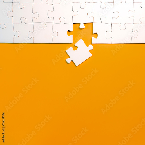 top view of jigsaw puzzle with one piece left, completing a task or solving a problem concept