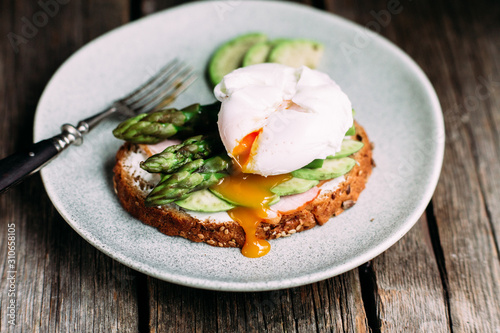 Sandwich with cream cheese, avocado, asparagus and poached egg