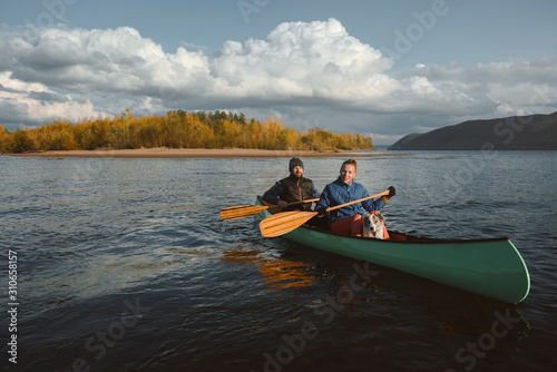 Happy couple in canoe at sunset.
