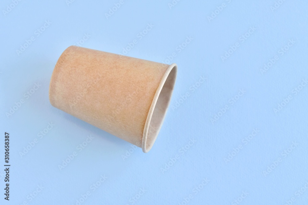Recycling craft paper cup of coffee to go on neutral background with copy space. Selective focus. Craft cup for hot beverage, takeaway. Disposable cup. Eco package. Cardboard coffee cup Recycling craft paper cup of coffee to go on neutral background with copy space. Selective focus. Craft cup for hot beverage, takeaway. Disposable cup. Eco package. Cardboard coffee cup