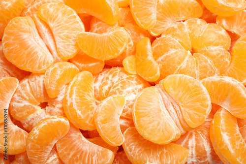 Fresh juicy tangerine segments as background, top view