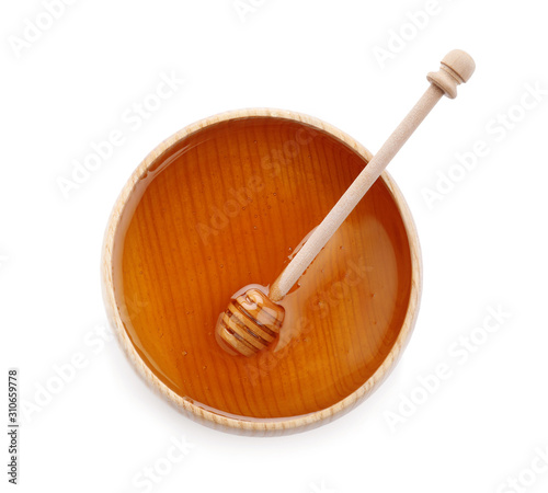 Bowl of organic honey and dipper isolated on white, top view