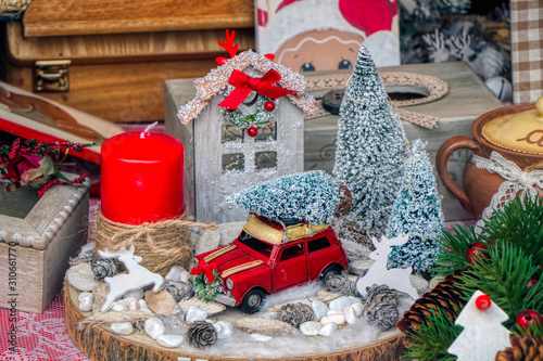 Colourful Christmas Market Stall. The stall sells Christmas decorations. Red car with christmas trees. © Massimo Todaro