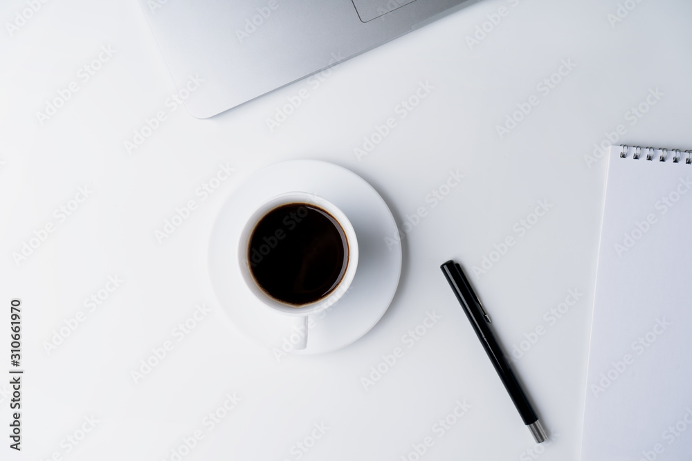 Office workspace with cup of coffee, notebook, pen, laptop on white background. Flat lay, top view Office workspace with cup of coffee, notebook, pen, laptop on white background. Flat lay, top view