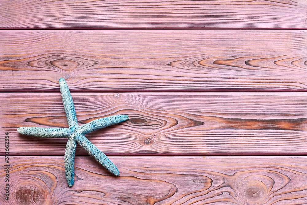 Starfish on a wooden purple background. Starfish on a wooden purple background.
