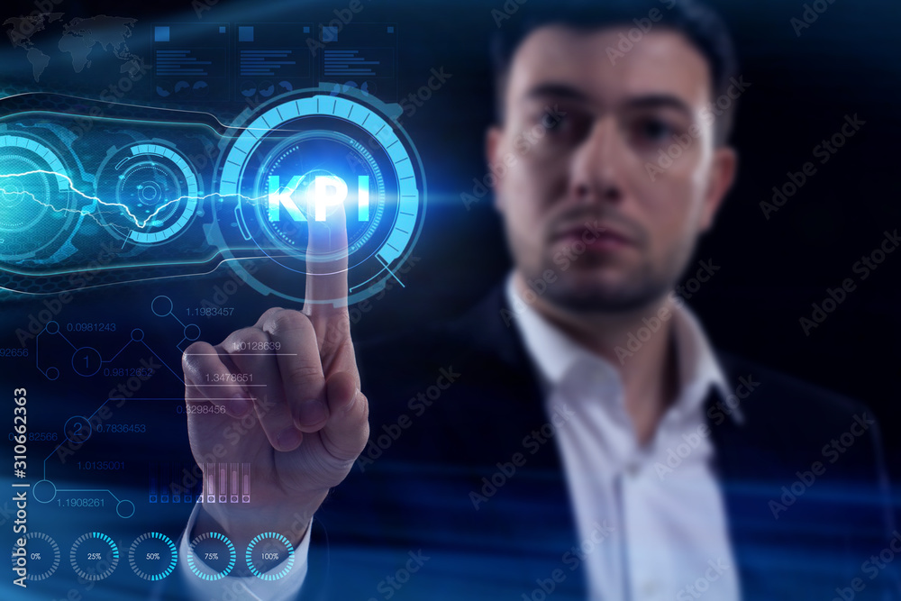 Business, Technology, Internet and network concept. Young businessman working on a virtual screen of the future and sees the inscription: KPI Business, Technology, Internet and network concept. Young businessman working on a virtual screen of the future and sees the inscription: KPI