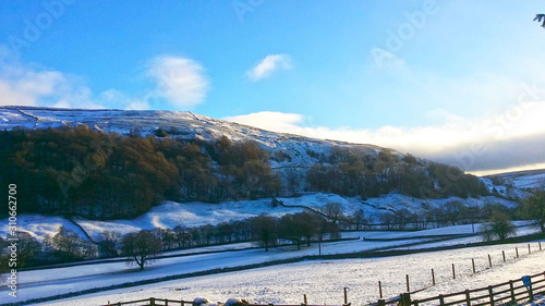 Beautiful landscape of winter season of blue sky and white cloud above snow covered on the hill and forest at North Yorkshire 