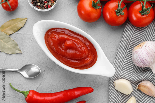Flat lay composition with tomato sauce on light grey table