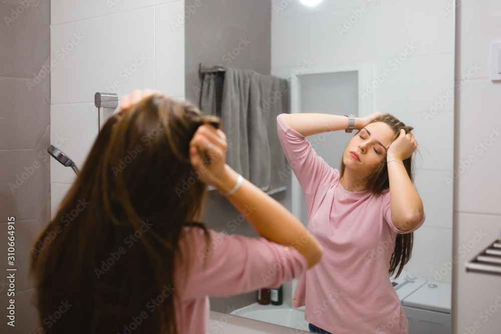 woman stretching up in bathroom, morning scene woman stretching up in bathroom, morning scene