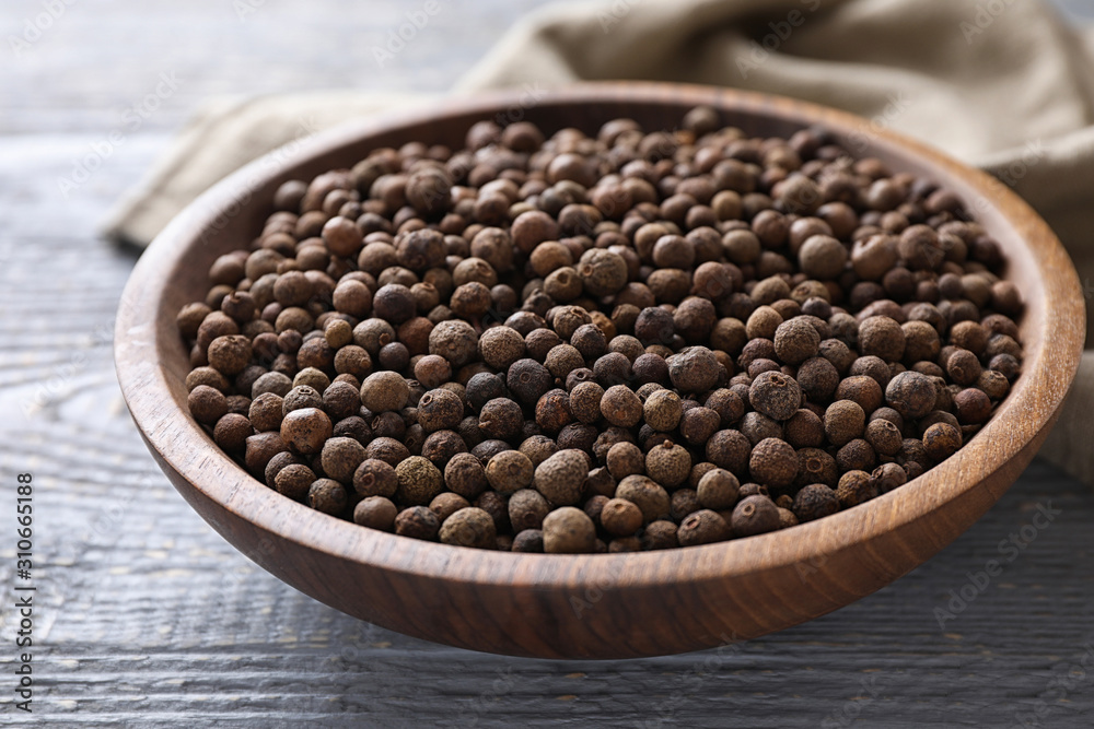 Peppercorns on light grey wooden table, closeup Peppercorns on light grey wooden table, closeup