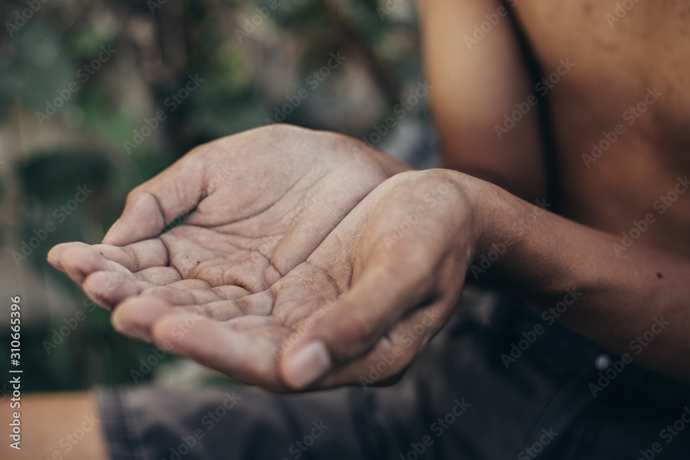 Fototapeta premium ręce biedne dziecko lub żebrak błagający cię o pomoc siedząc w brudnych slumsach. koncepcja ludzi ubóstwa lub głodu, praw człowieka, darowizn i działalności charytatywnej na rzecz upośledzonych dzieci w trzecim świecie