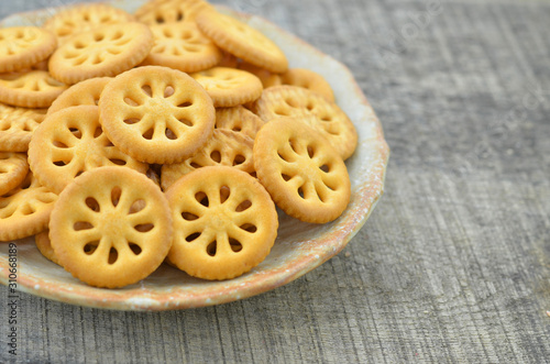 Delicious biscuit in plate on wooden background