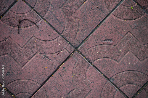 Texture of paving slabs overgrown with grass. Background image of a stratum stone