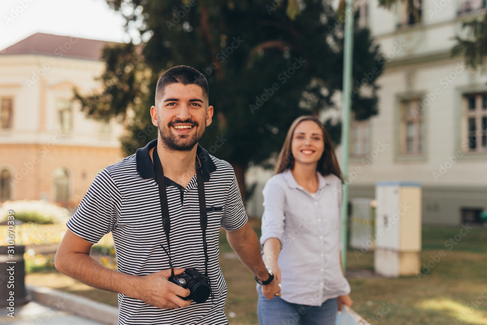 happy couple tourists outdoors exploring city
