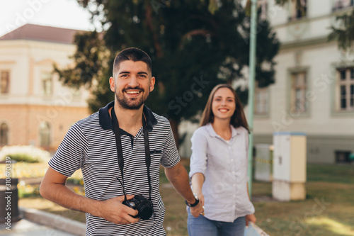 happy couple tourists outdoors exploring city