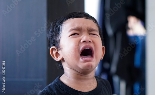Little Asian boy 2 year old He was cry due to being alone kid hungry asking mom to carry him.                                