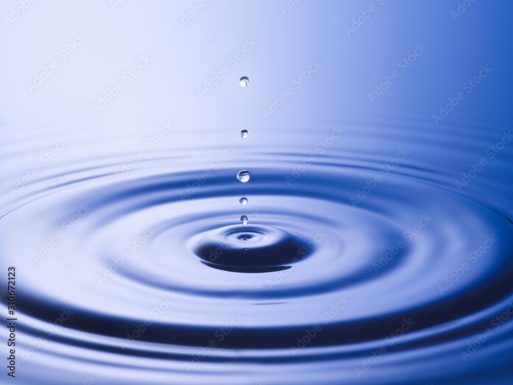 Drops hitting surface of water close-up Drops hitting surface of water close-up