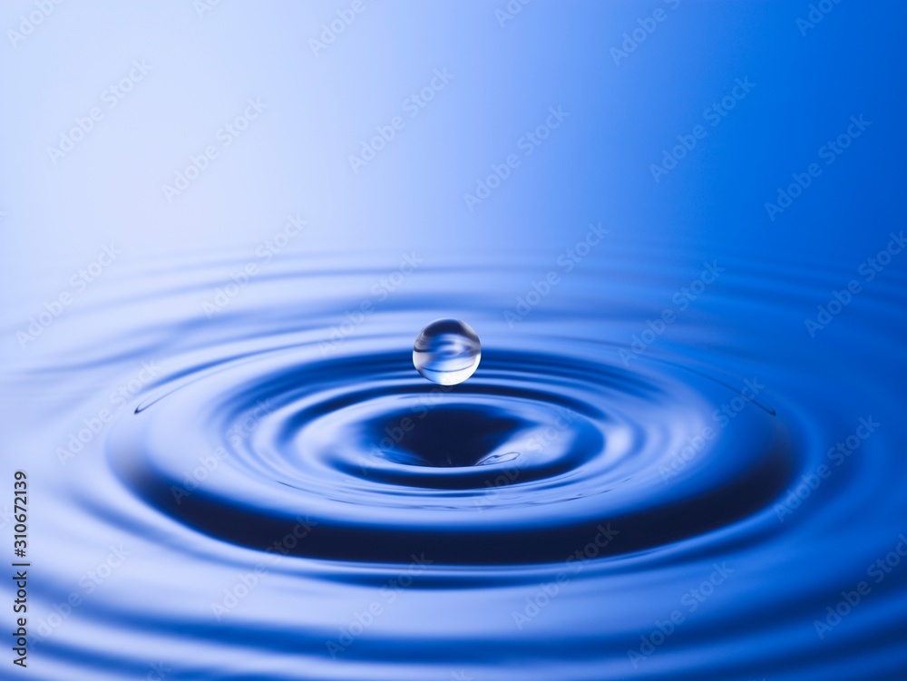 Drop hitting surface of water close-up Drop hitting surface of water close-up