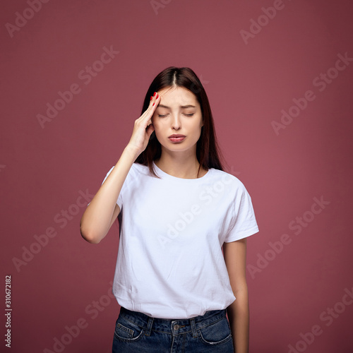 A young woman suffers from a headache.
