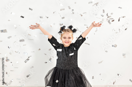 Party  holidays  new year and celebration concept - Female child throwing confetti.