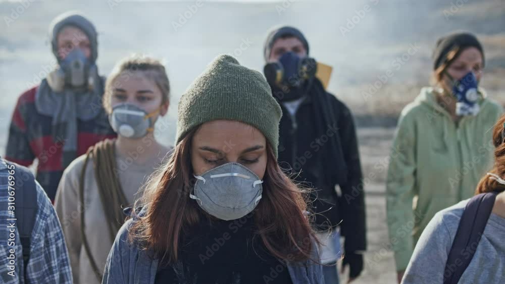 Portrait of exhausted girl in gas mask from the group of survivor people. Portrait of exhausted girl in gas mask from the group of survivor people.