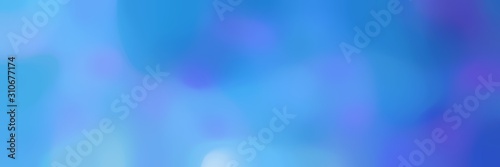blurred bokeh horizontal background with corn flower blue, royal blue and light sky blue colors and free text space