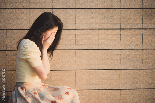 Asian woman sitting alone and depressed,stop abusing domestic violence, health anxiety.
