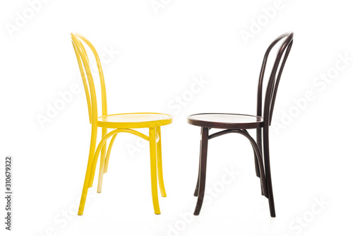 Yellow and brown wooden chairs isolated on white