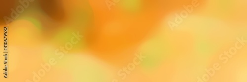 blurred bokeh horizontal background with pastel orange, golden rod and brown colors and space for text